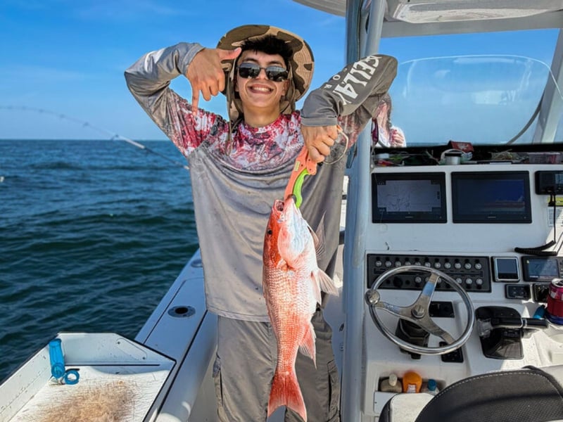 An angler showing off their fish