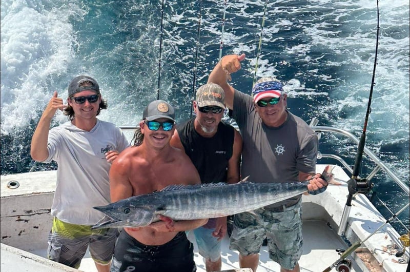 A group showing off their catches on the boat
