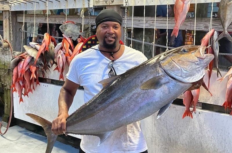 A man with an large Amberjack caught on Swoop II