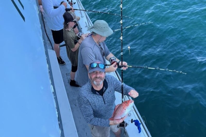 A group fishing off the side of Swoop II
