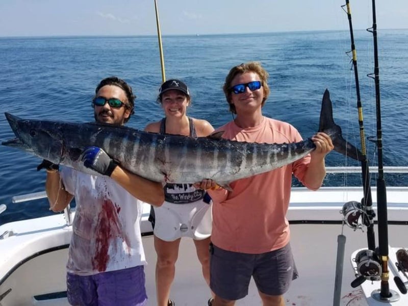 A group showing off their catch on board Shady Lady