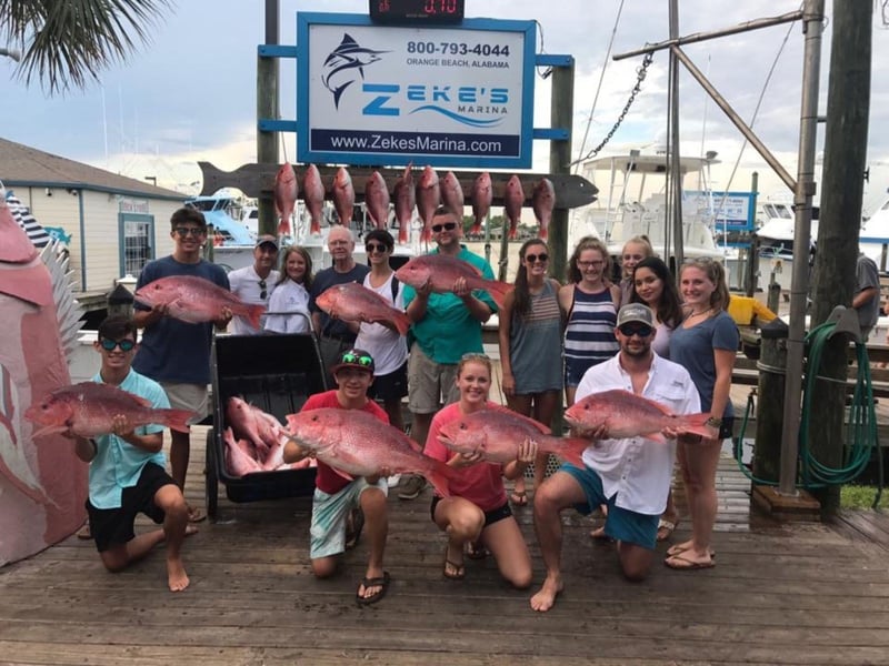 A group on the dock showing off their catches