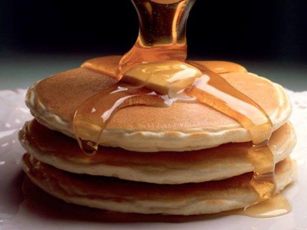 A fluffy pancake stack with syrup