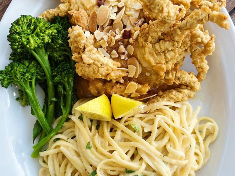 Fried soft shell crab served with pasta alfredo