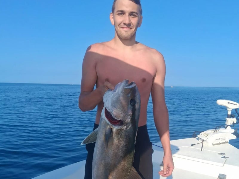 An guest with his catch on the boat