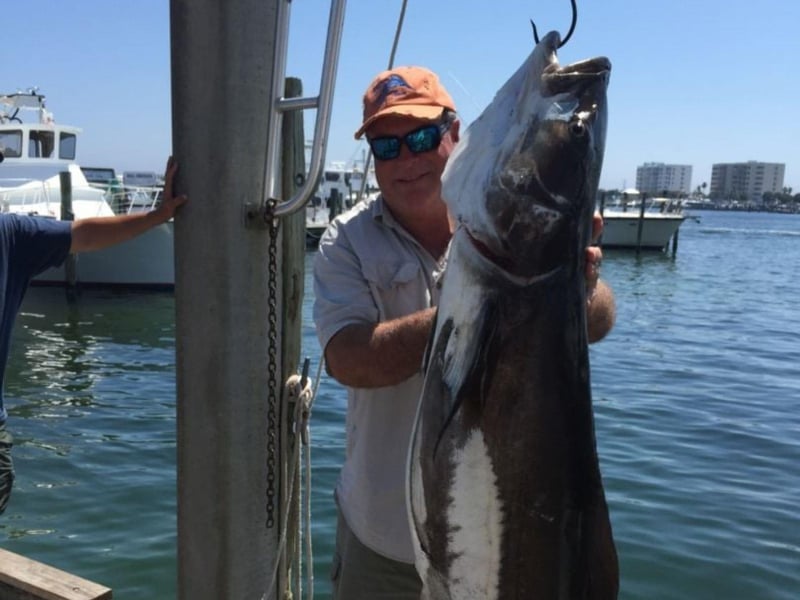 A man with his catch from Karma Charters LLC in Destin, Florida
