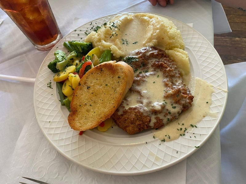 A dish with mashed potatoes and vegetables at Magnolia Grill