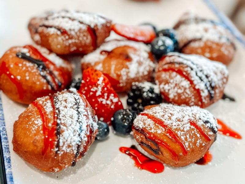 Beignets with chocolate and raspberry sauce