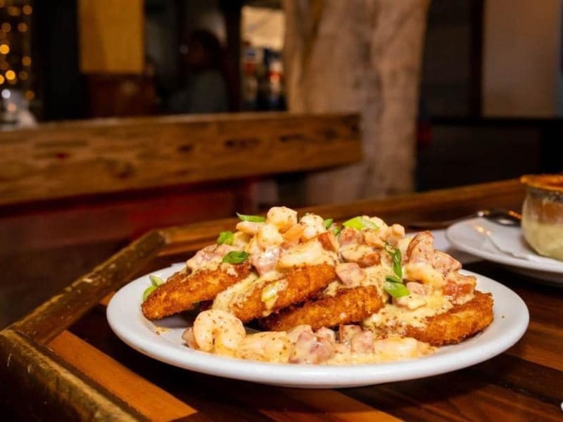 Fried green tomatoes topped with shrimp and andouille sausage