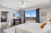 Spacious Primary Bedroom walks out to an incredible view of a picturesque marina and sparkling Intracoastal Waterway, with 8 miles of natural, undeveloped beach as a backdrop.