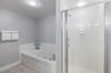Separate shower, jetted tub and double vanities are featured in this Primary Bath.