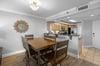 Breakfast bar separates kitchen from dining  living area.