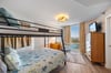 Guest bedroom with full over queen bunk bed.