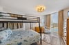 Guest bedroom with full over queen bunk bed.