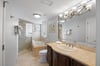 Primary bathroom is en suite and offers a separate shower and jetted tub.