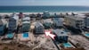 Private balcony with comfortable seating—perfect for morning coffee and coastal breezes just steps from the beach