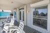 Welcoming front porch with seating—an inviting spot to unwind after a day at the beach