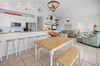 Open layout connects kitchen, dining, and living areas—great for groups and families