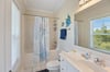 Full guest bathroom with tubshower combo—gives everyone their own space to get ready