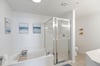 Garden tub and separate shower with double vanities.