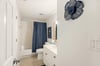 Guest bath has a convenient tubshower combo.