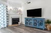 Living area with large TV and custom fireplace mantel