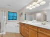 Primary Bathroom featuring a Soaking Tub and Double Vanity