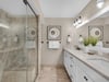 Elegant Primary Bathroom with WalkIn Shower and Double Vanities