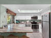 Spacious Kitchen with Bar Seating and Window to Screened Patio