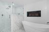 Primary Bathroom with Gas Fireplace above Large Tub