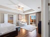Bedroom 1 your primary suite offers elegant tray ceiling and private balcony access for peaceful moments.