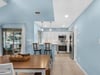 Your bright, airy kitchen flows seamlessly into the dining area, where ocean breezes and natural light create the perfect space for morning coffee.