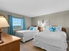 Rest easy in your double bedroom with crisp linens, cheerful turquoise accents, and a peaceful view to start each morning refreshed.