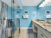 Unwind in your serene spastyle bathroom with calming blue walls, marble countertops, and a luxurious walkin shower.