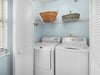 Your private laundry room with fullsize washer and dryer makes longer stays effortless, complete with storage baskets for your convenience.