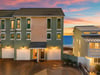 Multilevel beach property with private garages and stunning Gulf views at sunset, perfectly positioned near the sandy shoreline.