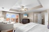 Spacious master suite with private balcony access and cozy seating area—perfect for morning coffee or evening relaxation.