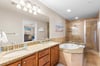 Unwind in the luxurious ensuite featuring a soaking tub, granite countertops, and elegant tile finishes—your personal spa retreat after a long beach day.