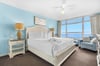 Bedrooom1 Wake up to breathtaking ocean views from your comfortable bed. Soft blue walls and coastal furnishings create a serene retreat.