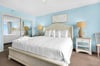 Bedroom 1 Drift off in your serene coastal bedroom, where soft blue walls and crisp white linens create a peaceful retreat for restful nights.