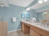 Bathroom 1 Refresh in your spacious bathroom featuring dual vanities, plush towels, and soothing coastal colors that create a spalike retreat.