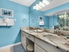 Bathroom 1  Refresh in your elegant bathroom with marble countertops, dual sinks, and cheerful blue walls that brighten every morning routine.