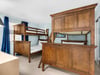 Bedroom 2 Spacious bunk room with custombuilt wooden beds perfect for family getaways, featuring ample storage and cheerful blue accents throughout your stay.