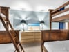 Bedroom 2  Your coastalthemed bedroom features sturdy bunk beds with crisp linens, tropical decor, and entertainment perfect for family adventures.