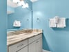 Bathroom 2  Your private bathroom features a stunning marble vanity and soothing blue walls, creating a spalike atmosphere for your morning routine.