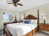 Bedroom 1 Sink into your kingsize fourposter bed with ocean views peeking through the doorway, warmed by gentle ceiling fan breezes.