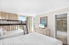 Your spacious family room features comfortable beds plus fun bunk beds, with your own TV and bright windows overlooking the area.