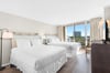 Relax in your bright bedroom with two comfortable beds, city views, and modern amenities for a perfect getaway.