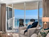 Unwind in this bright oceanfront living space where floortoceiling windows frame endless sea views from your private balcony.