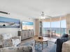 Relax in your bright coastal living space with stunning ocean views from your private balcony and comfortable seating for unwinding.
